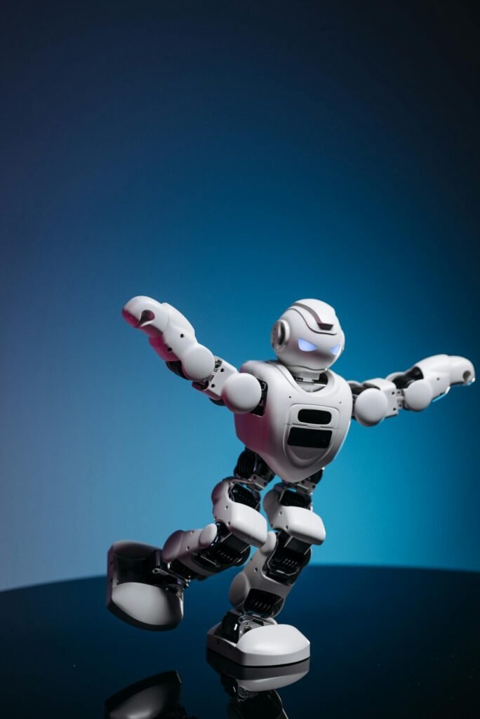 White humanoid toy robot with glowing eyes displayed in a dynamic pose.